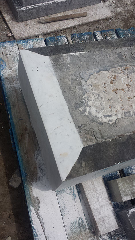 Picture of the lower base from the stone where we have initially just begun remove the surface of the marble to reveal the original beauty hidden behind its current exterior.