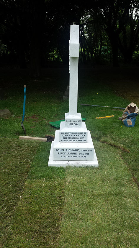 A side elevation of the stone showing it to be straight and true, & the grave area now levelled. The dark background showing how striking this century old memorial has become.