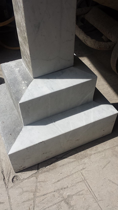 A picture here showing yet more early stages of this lengthy restoration of the marble bases. You can clearly see the striking white against the current exterior.