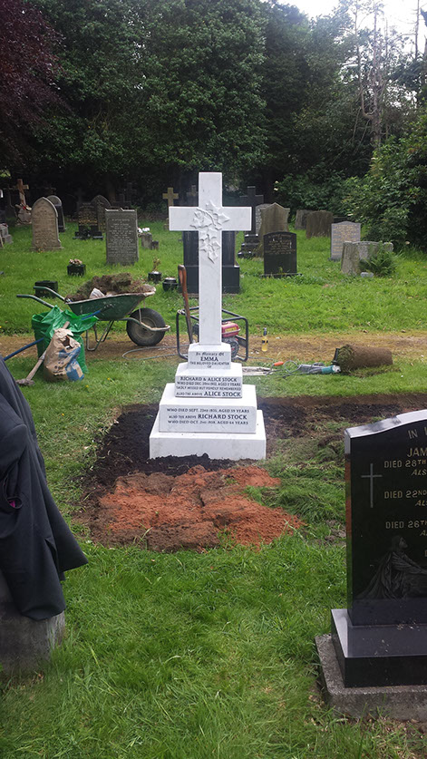 The total area of the grave is levelled using layers of sharp sand and top soil, making sure that the ground is heavily compacted between each layer.
